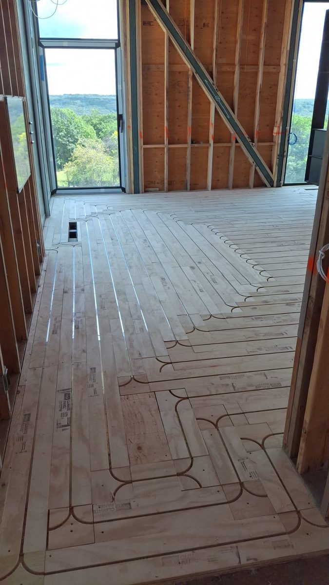 Close-up of radiant heating channels in prepared subfloor